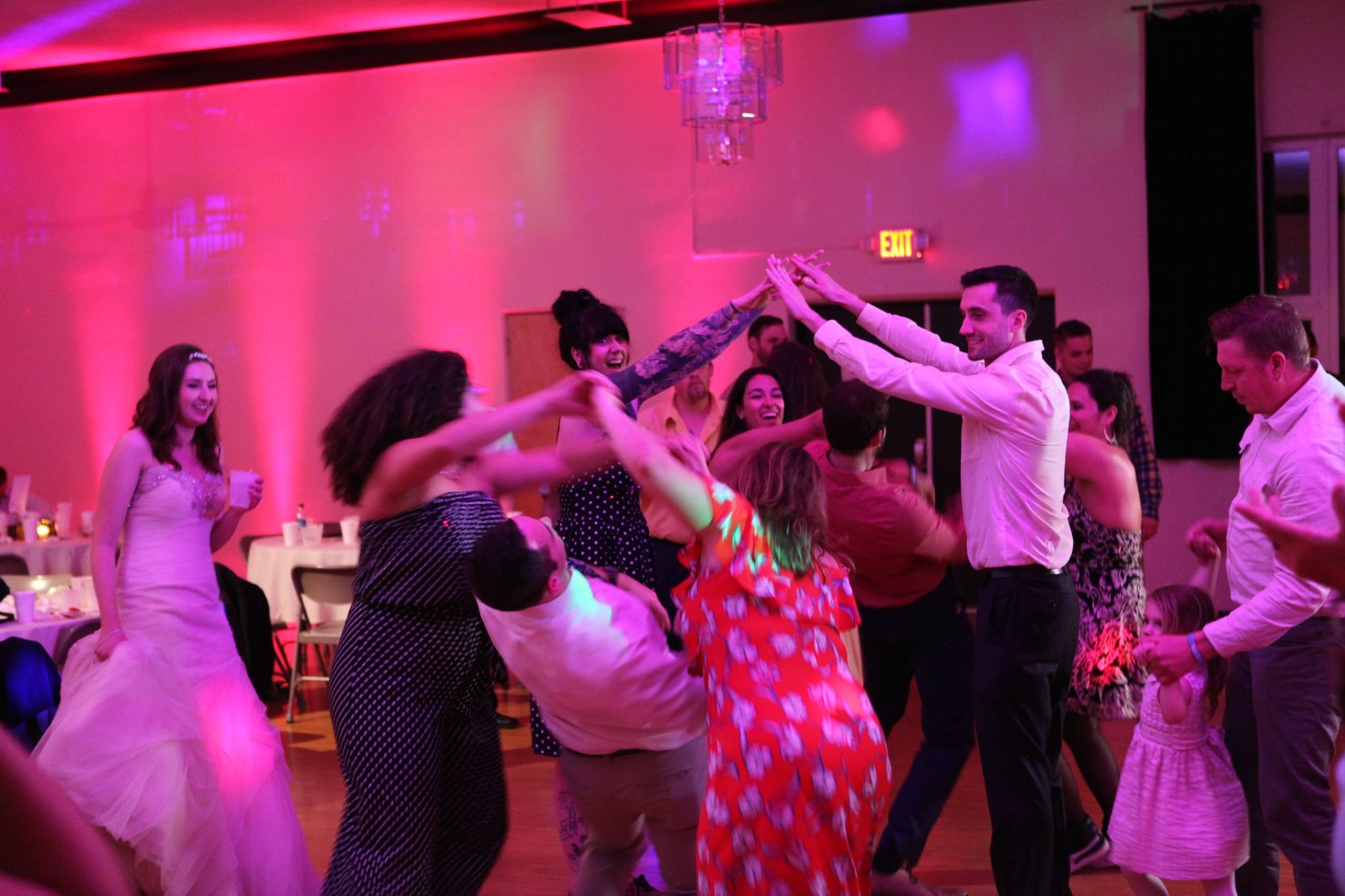 A group of people dancing in a room.