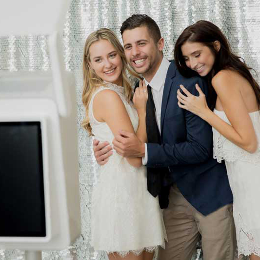 A man and two women posing for a picture.