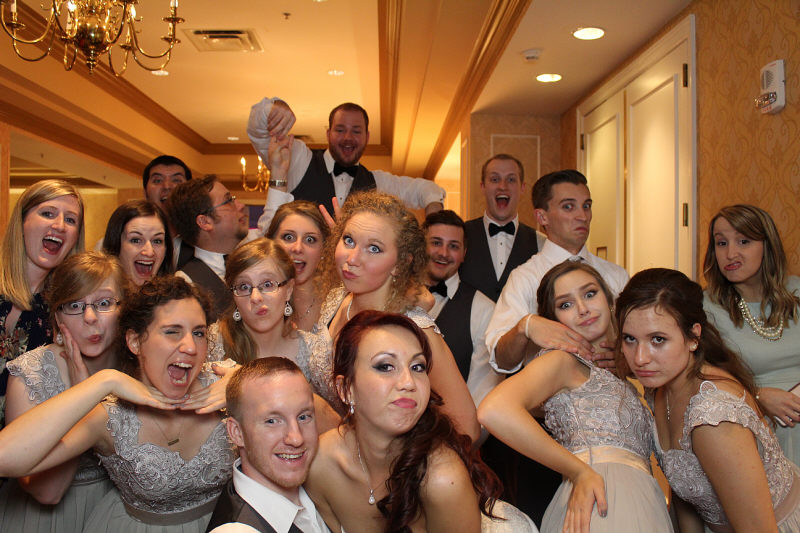 A group of people in formal wear posing for the camera.