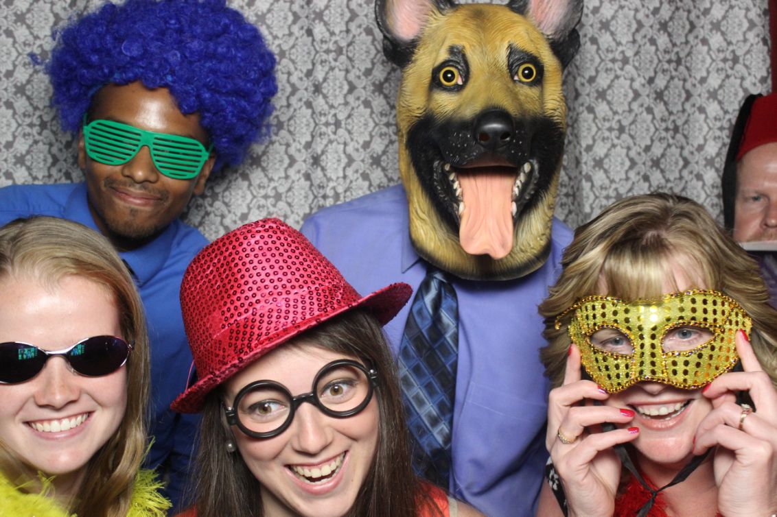 A group of people wearing masks and wigs.