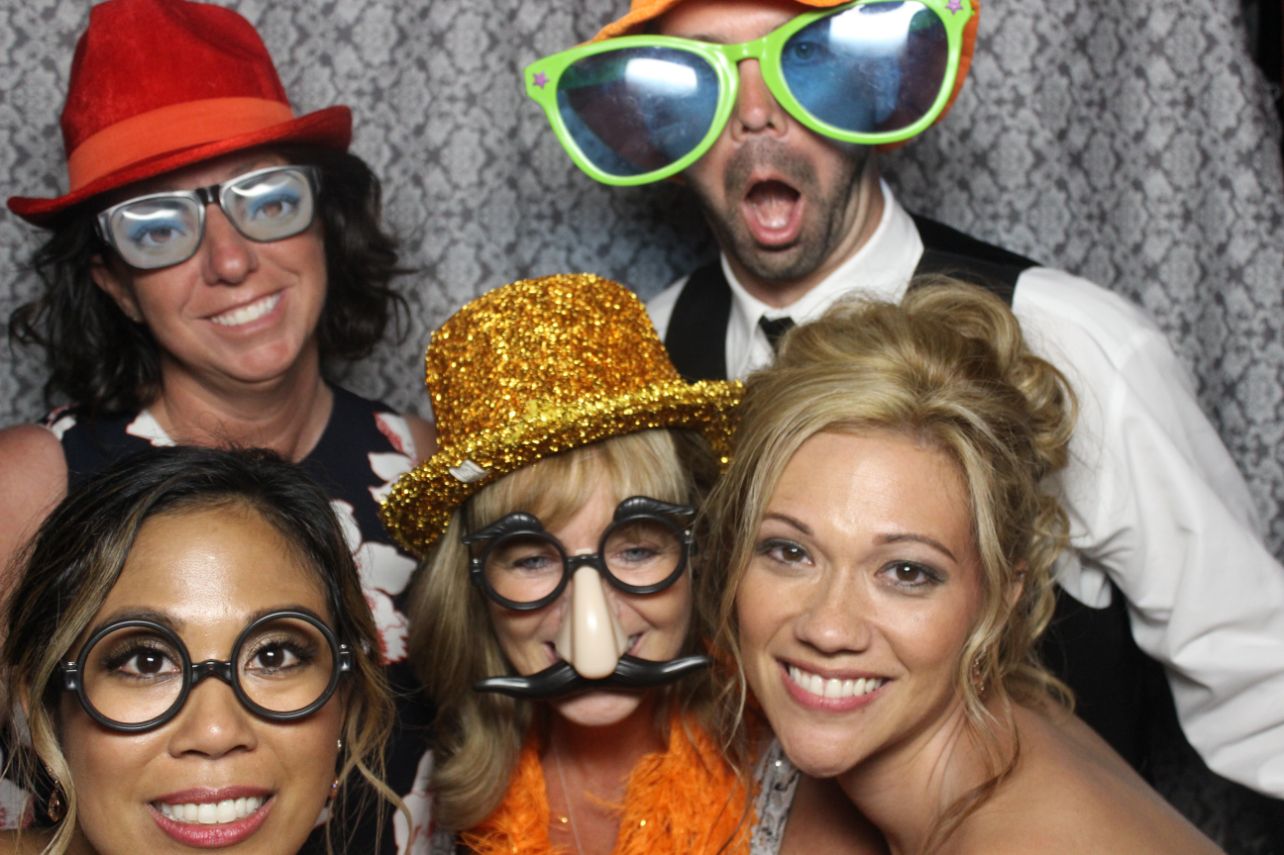 A group of people posing for a photo booth.